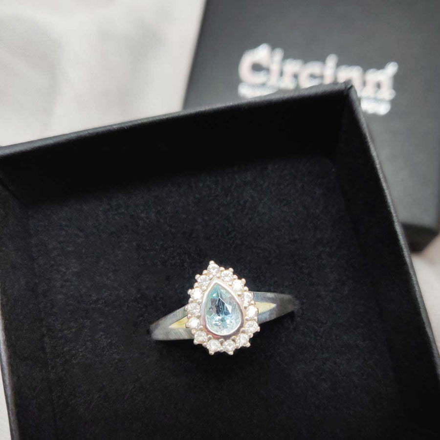 Pear cut aquamarine and white sapphire cluster ring in argentium silver in branded box