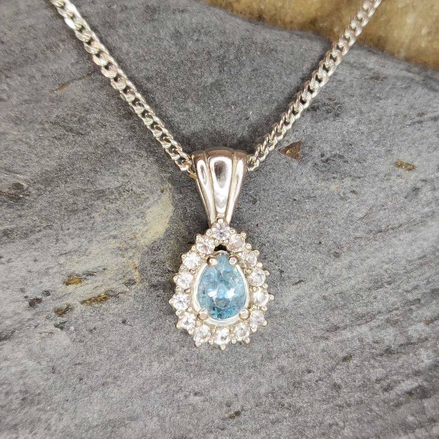 Pear cut aquamarine cluster necklace in argentium silver on slate background
