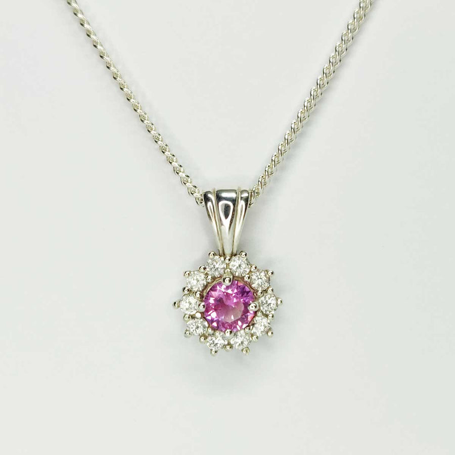 Pink and white sapphire cluster necklace in argentium silver on white background