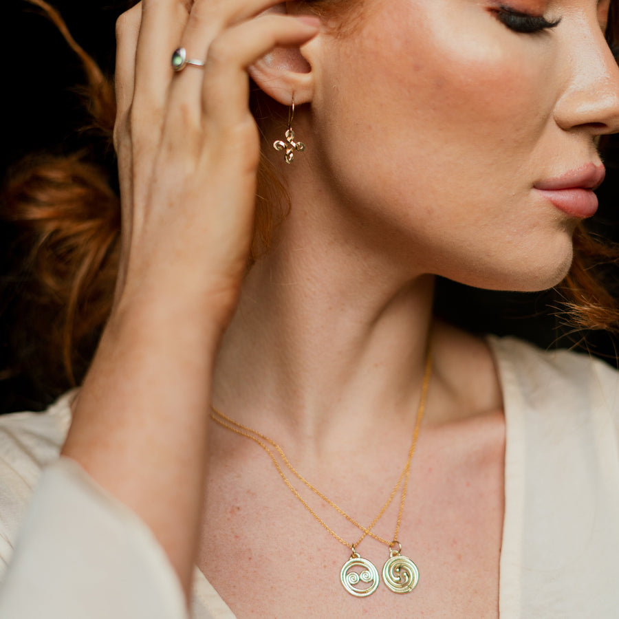 Red-haired model wearing a Gold Celtic Equinox Sun and Moon Gold Necklace.