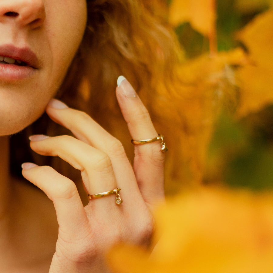 Solid Gold Heart and Diamond Charm Rings being worn