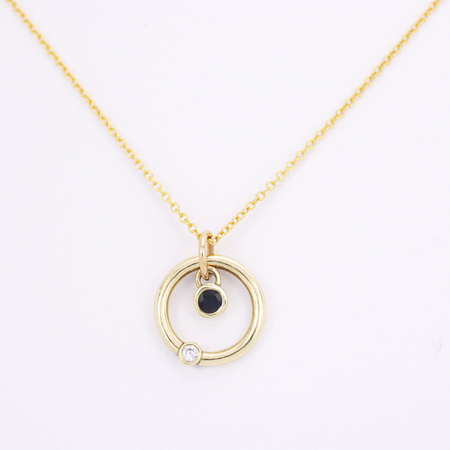 Solasta yellow gold sapphire and diamond pendant and chain on a white background.