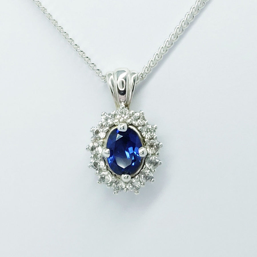 Blue and white sapphire necklace on a white background.