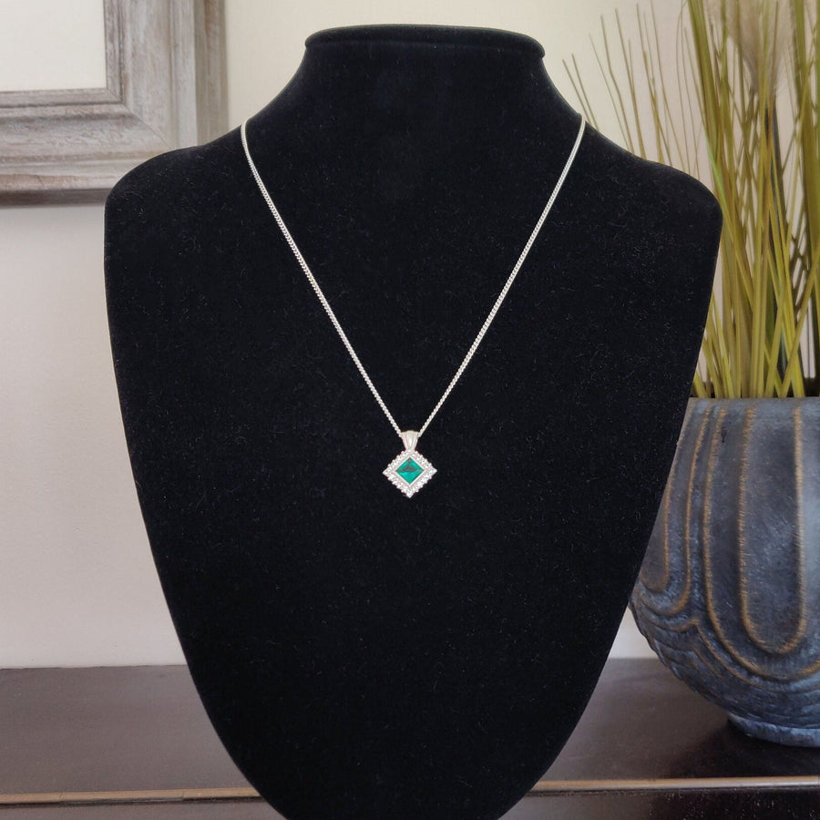 Princess Emerald and Diamond Cluster Necklace on a black model bust