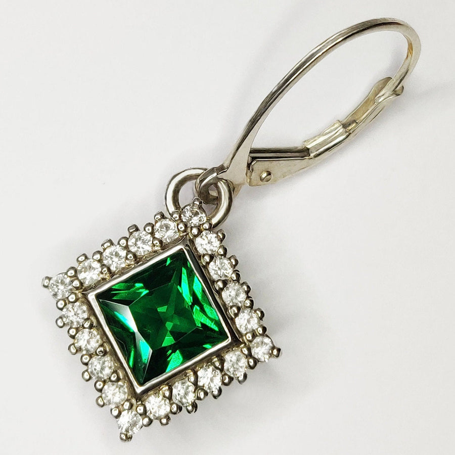 Princess Cut Emerald and Diamond Halo Earring ona  white background