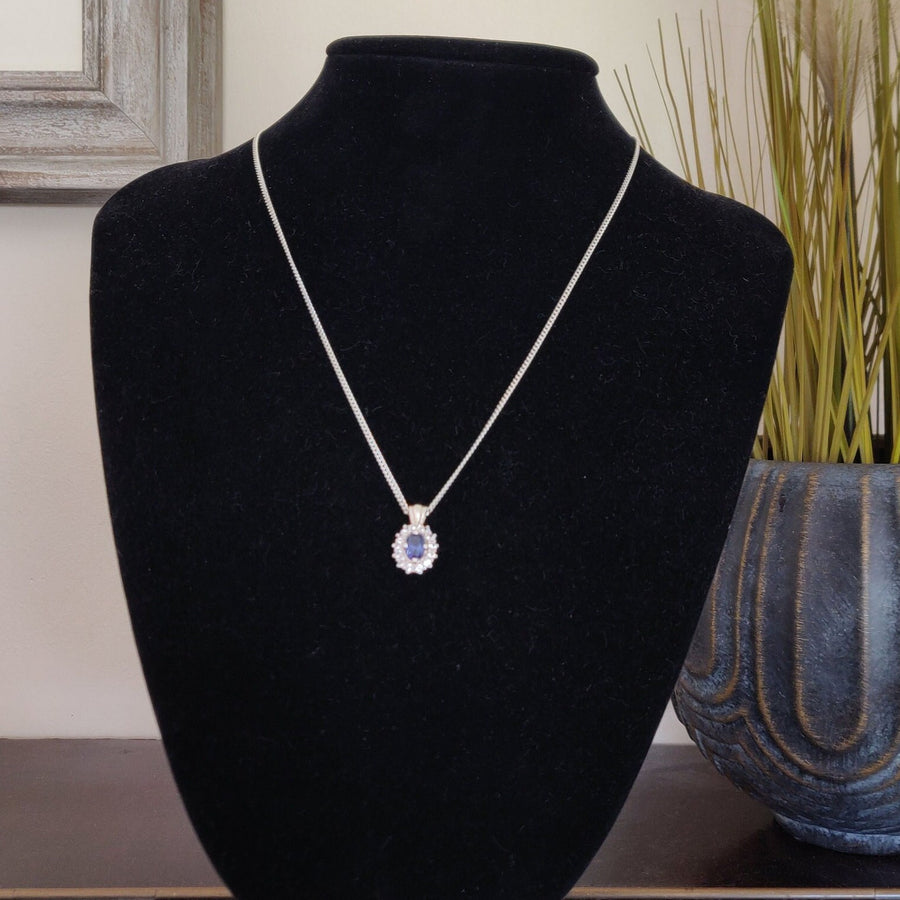 Sapphire pave pendant in argentium silver on a display bust.