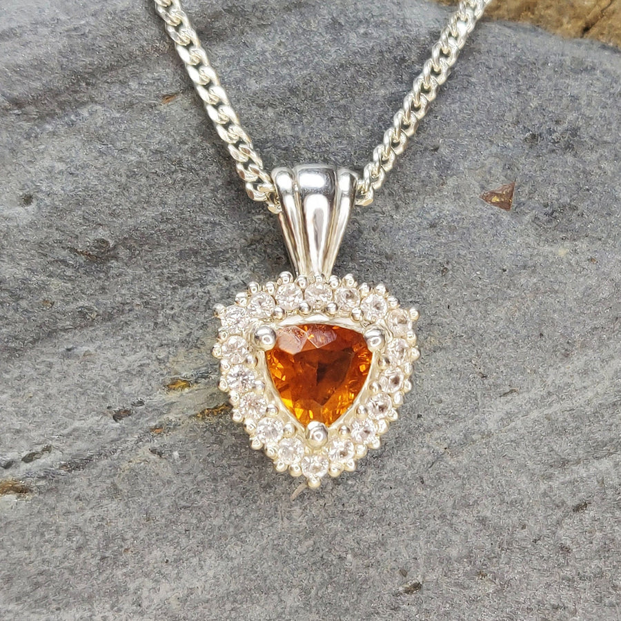 Silver Citrine and Sapphire Cluster Necklace on a slate background