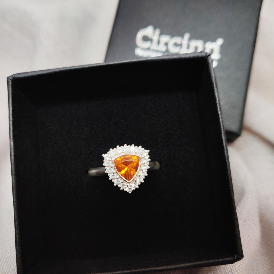 Top view of atrillion cut citrine and white sapphire halo cluster pave ring in a branded Circinn ring box.