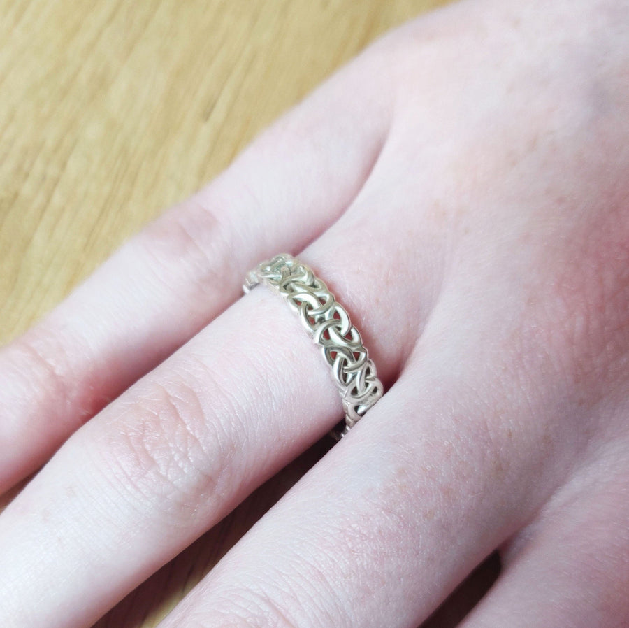 Ladies Triquetra Pattern Celtic Knot Wedding Ring on a  hand.