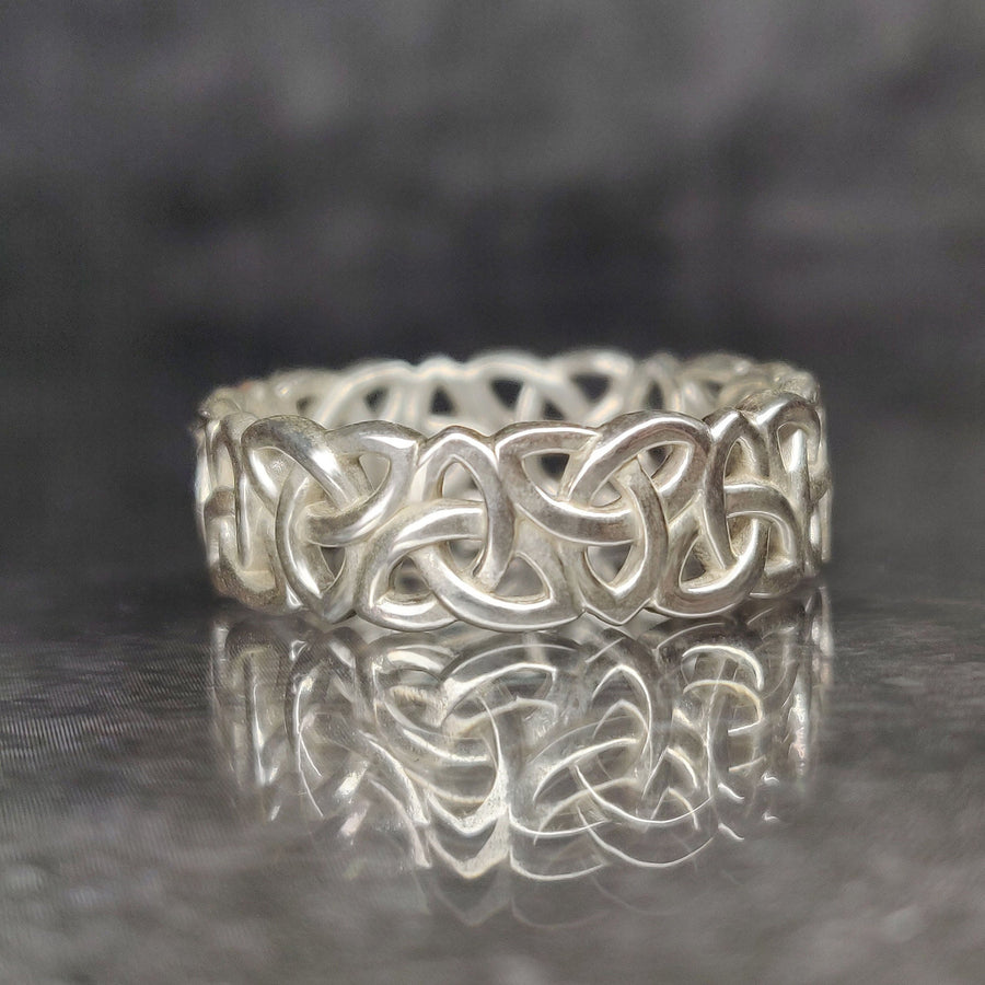 Gents Triquetra Celtic Knot Viking Wedding Ring on a Reflective Background.