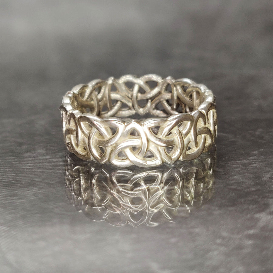 Gents Triquetra Celtic Knot Viking Wedding Ring on a Reflective Background.