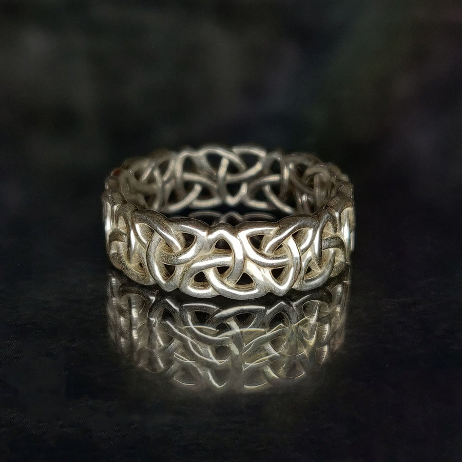 Gents Triquetra Celtic Knot Viking Wedding Ring on a Reflective Background.