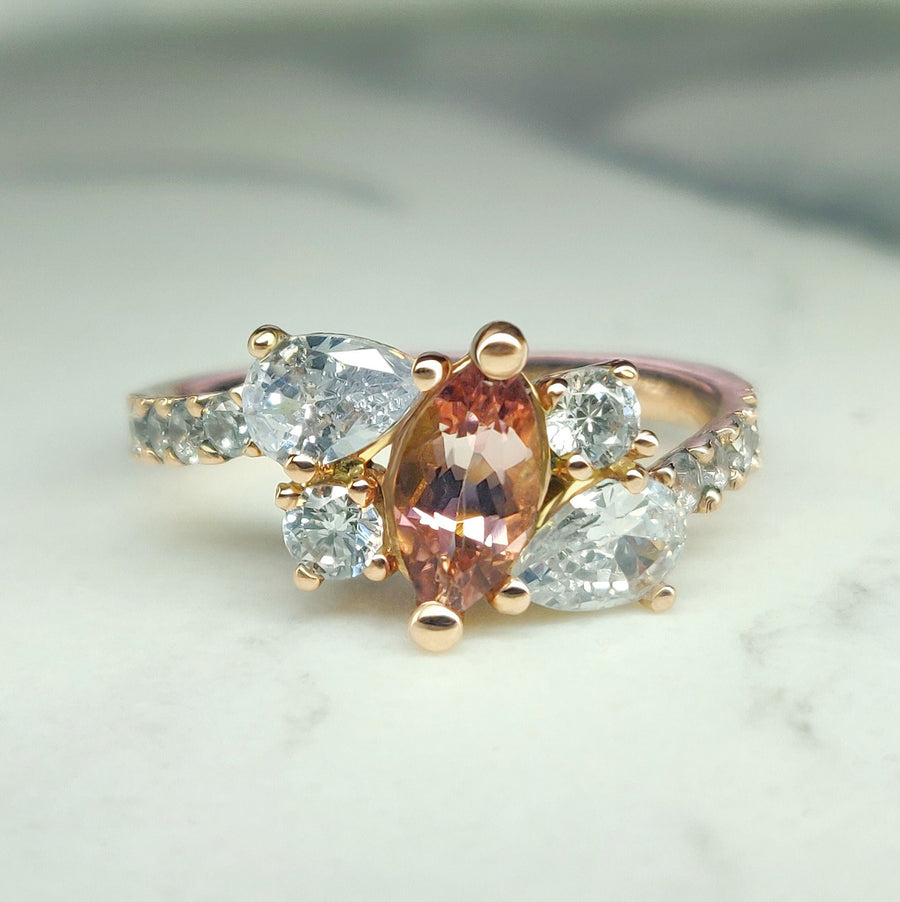 Bi Colour Tourmaline and lab-grown diamond gold engagement ring on a marble background