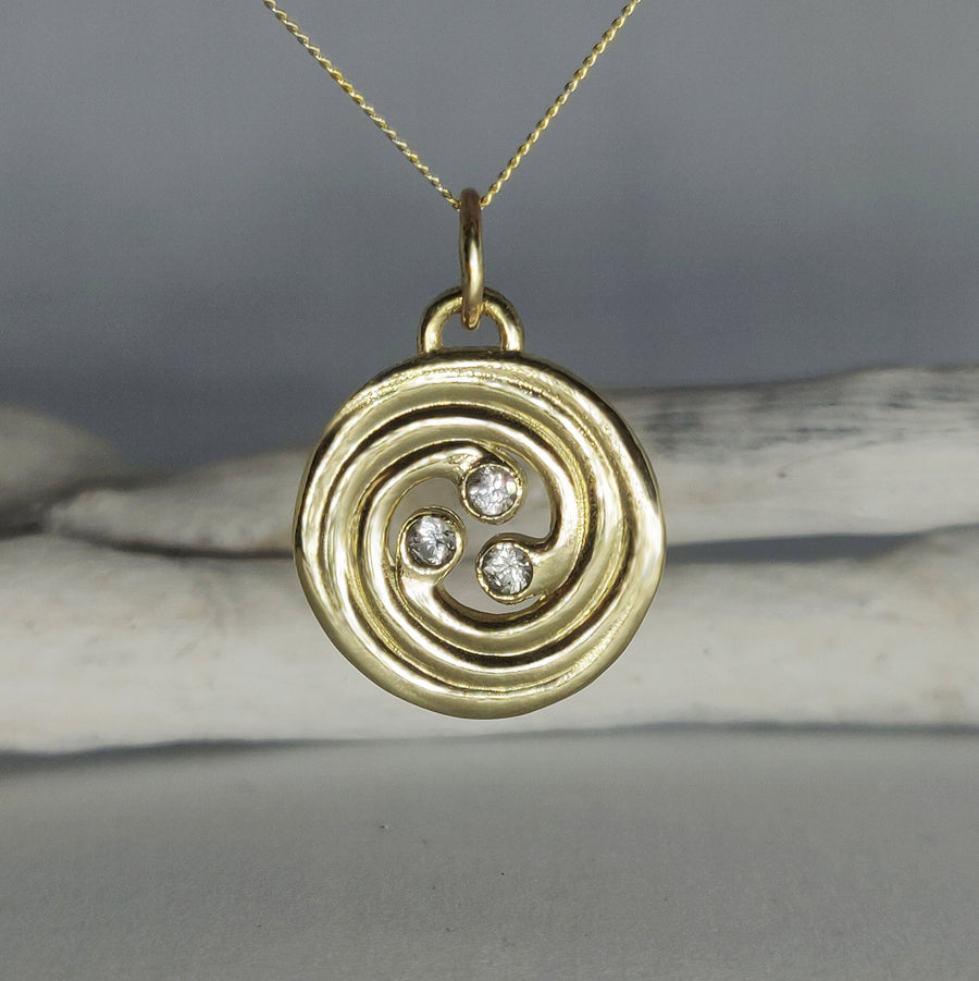 Front view of a 14ct yellow gold celtic knot pendant with lab grown diamonds against a white background.