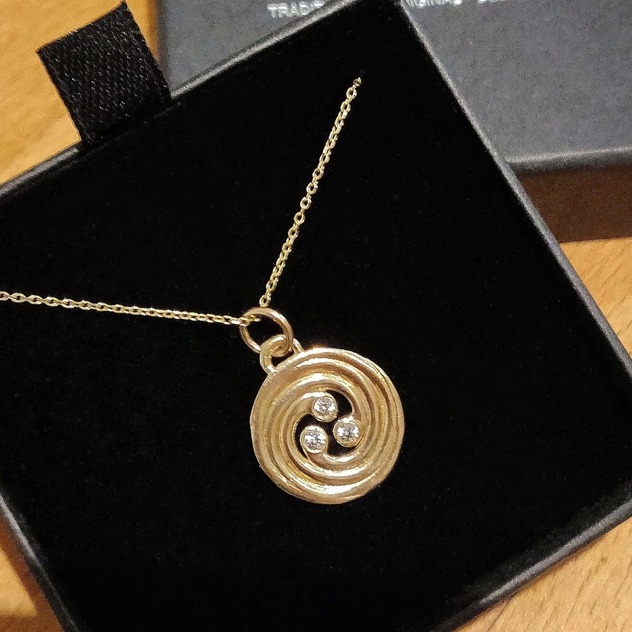 Boxed image of a celtic knot spiral necklace with diamonds.