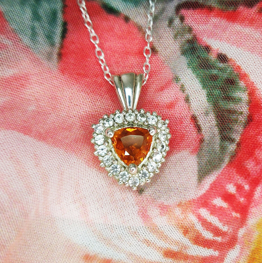 940 Argentium Sterling SilverCitrine and Sapphire Cluster Necklace on a cloth background