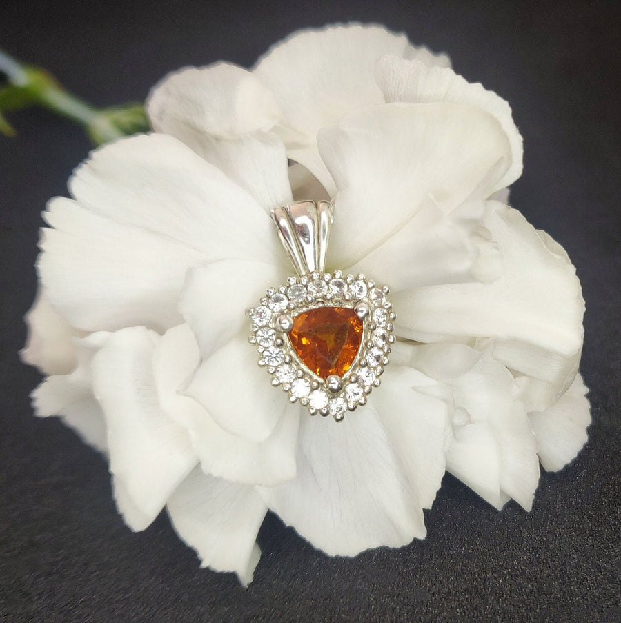 Silver Citrine and Sapphire Cluster Necklace on a flower background