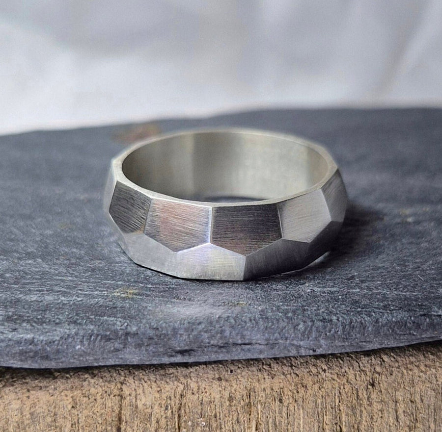 Argentium sterling silver geometric pattern ring on a slate.
