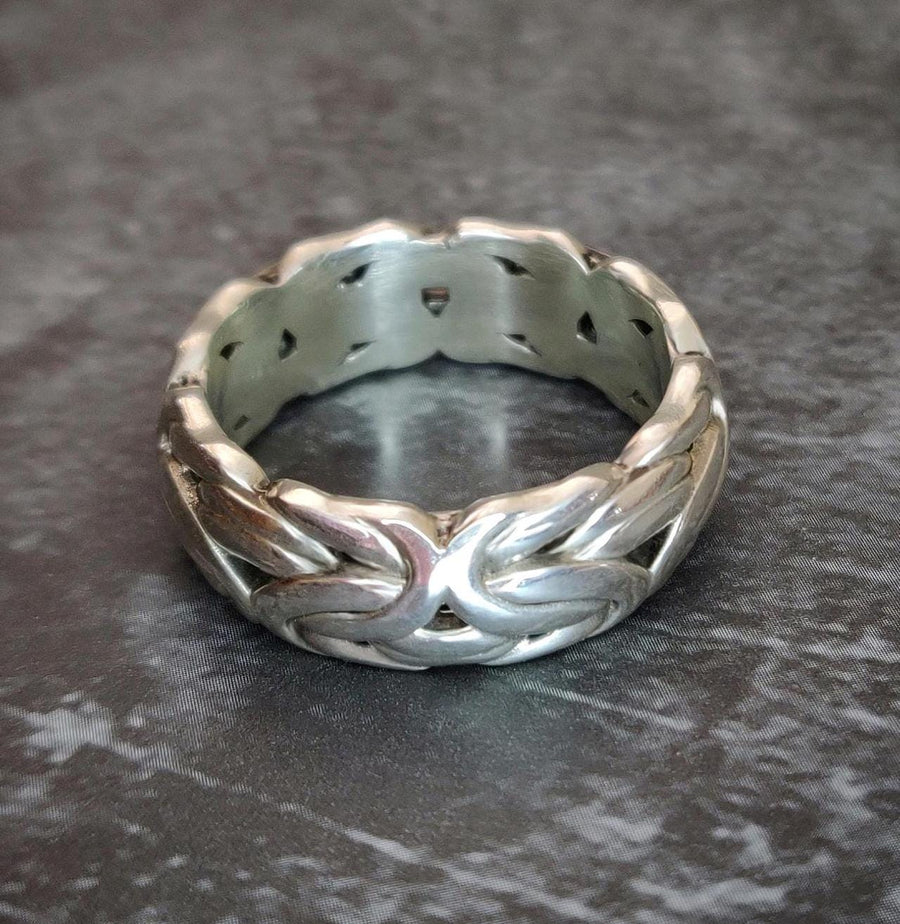 Byzantine style ring in silver on a table top.