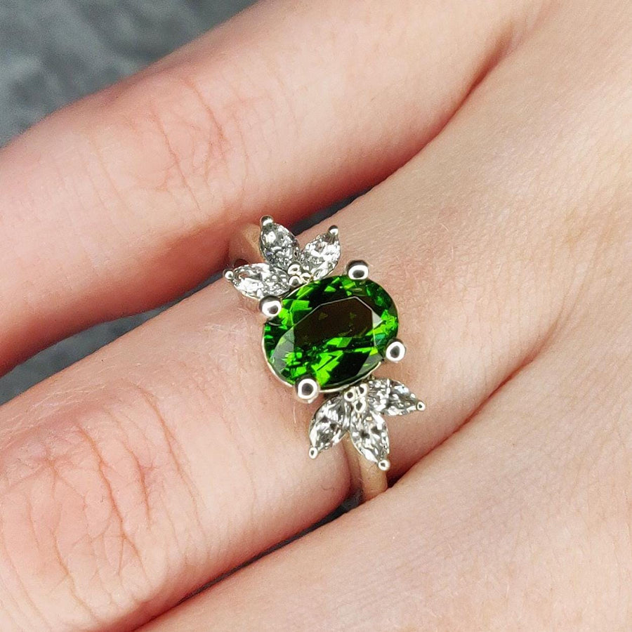 Marquise diamond and Tourmaline white gold ring being worn.