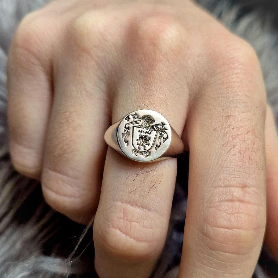 Hand wearing an argentium silver family crest coat of arms ring