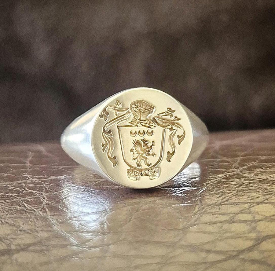 Coat of arms ring reversed sigil silver ring on leather background