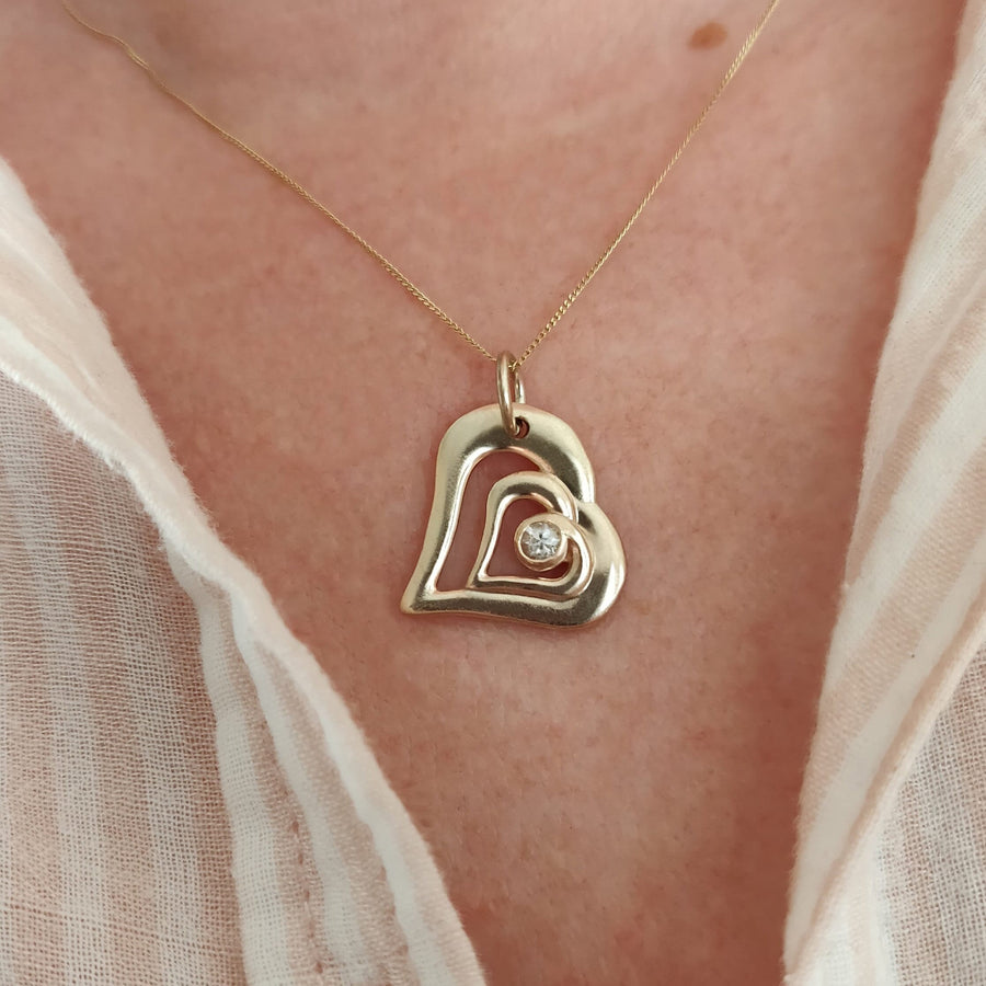 Gold and Diamond Heart Pendant being worn.