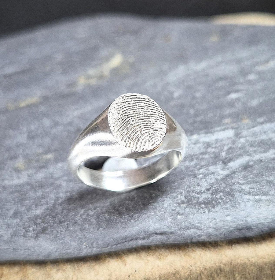 Silver fingerprint ring shown from the top