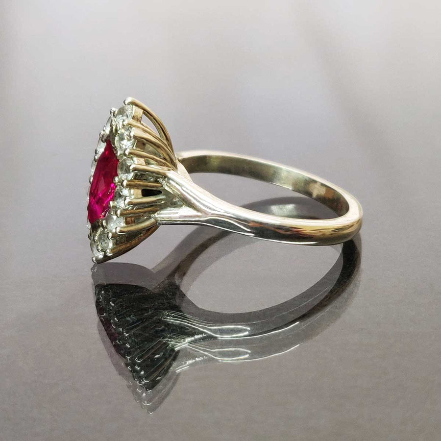 Ruby Marquise and white sapphire cluster ring in argentium silver from side on glass