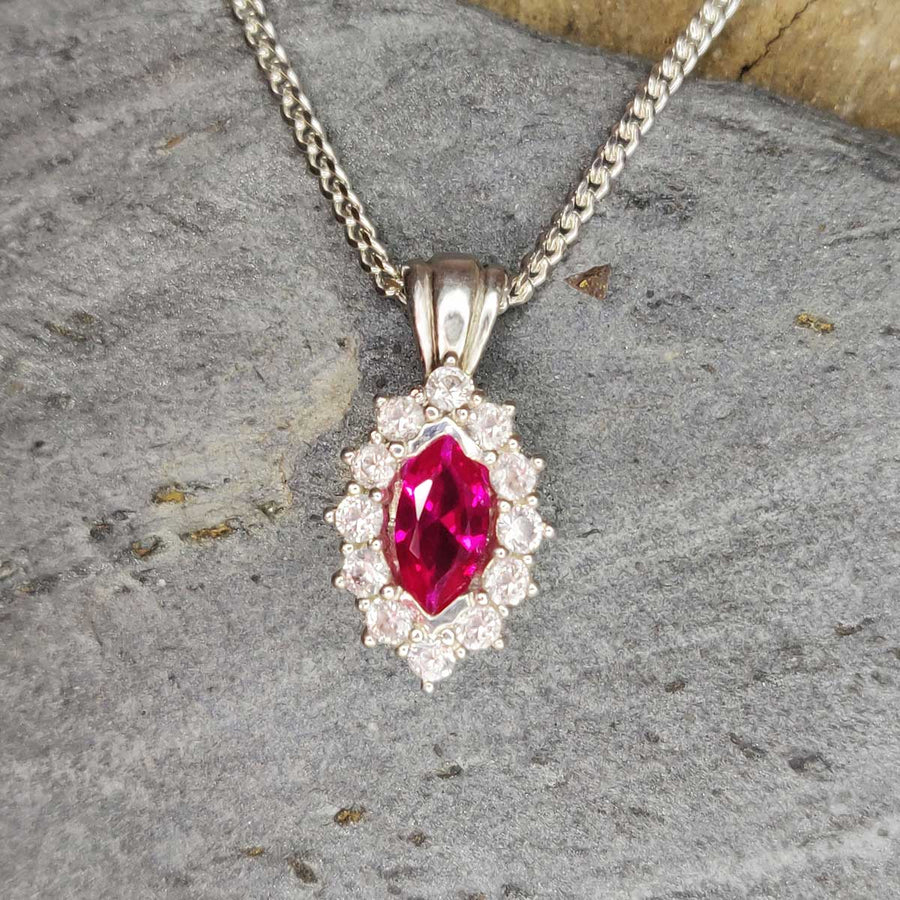 Ruby Marquise and white sapphire cluster necklace in argentium silver on slate background