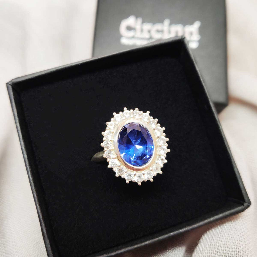 Blue and white sapphire cluster ring in argentium silver in branded box