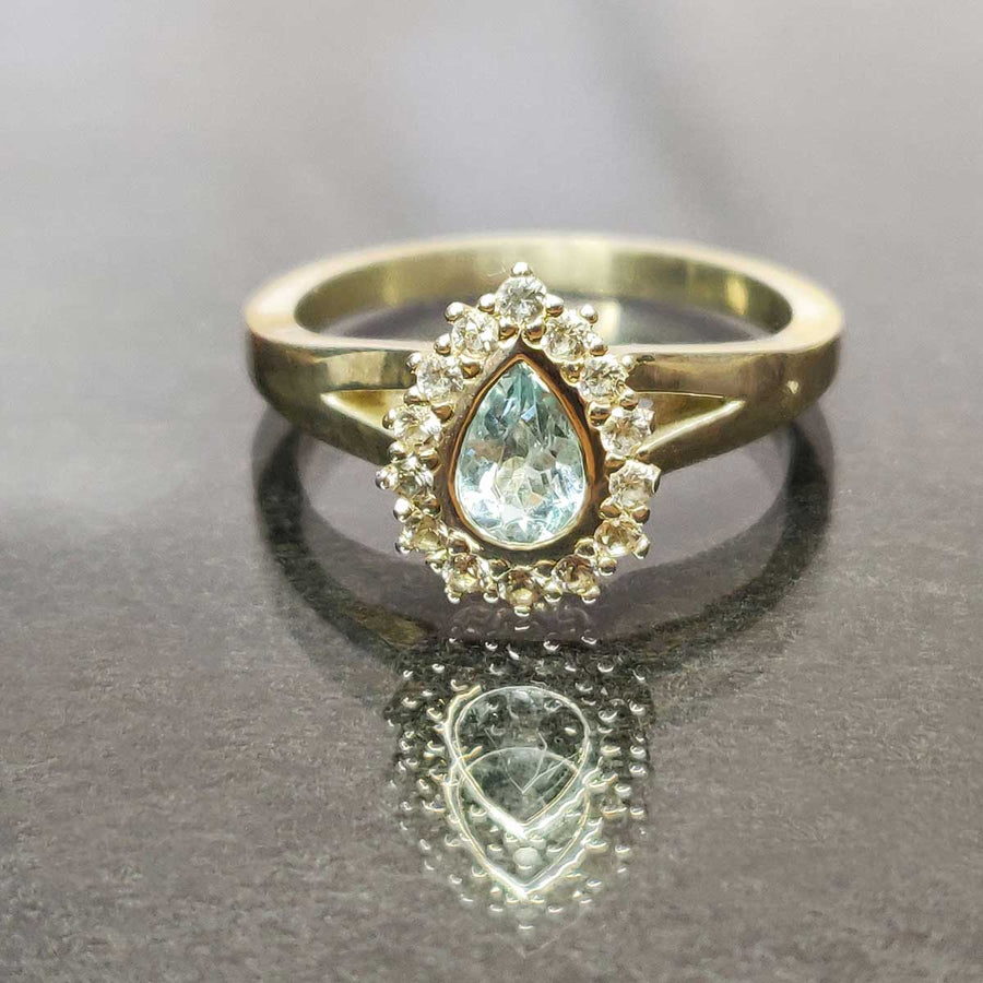Pear cut aquamarine and white sapphire cluster ring in argentium silver on glass