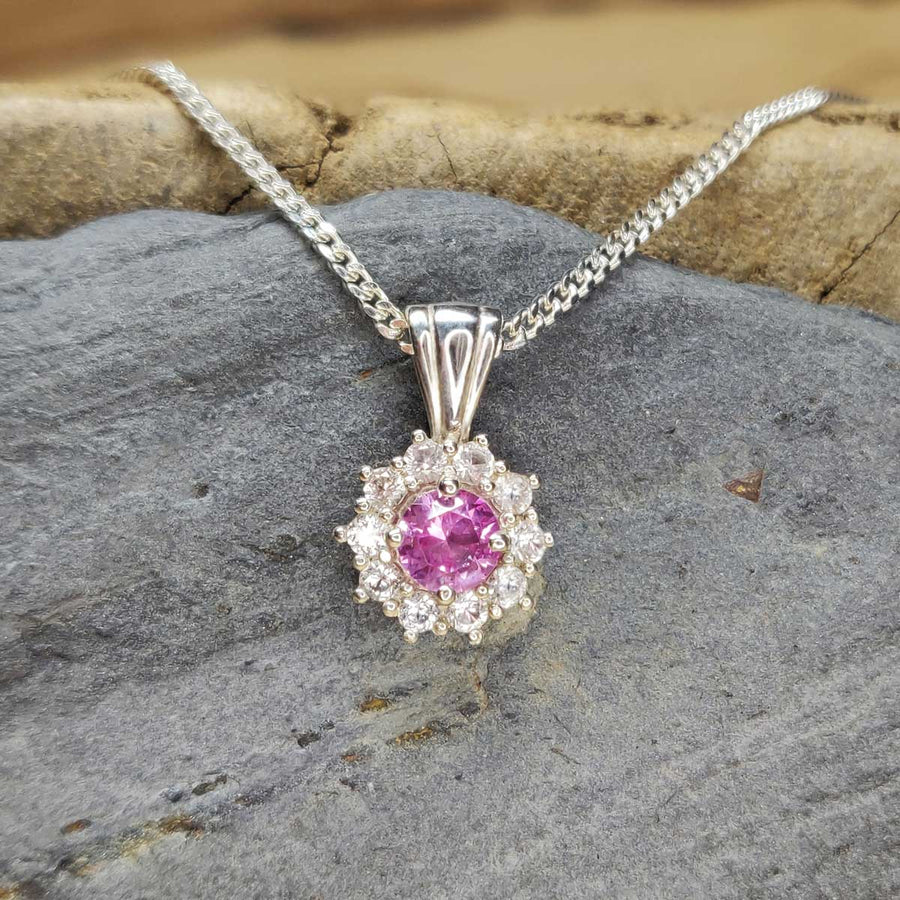 Pink and white sapphire cluster necklace in argentium silver on slate background