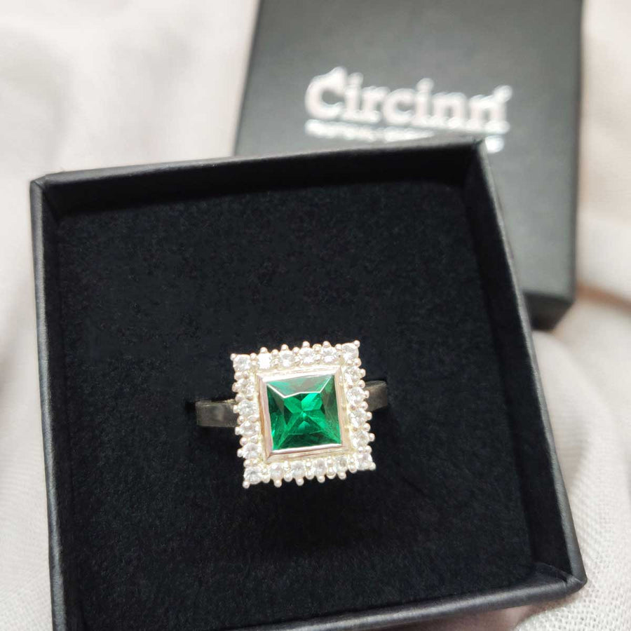 Princess cut emerald with white sapphire cluster in argentium silver in branded box
