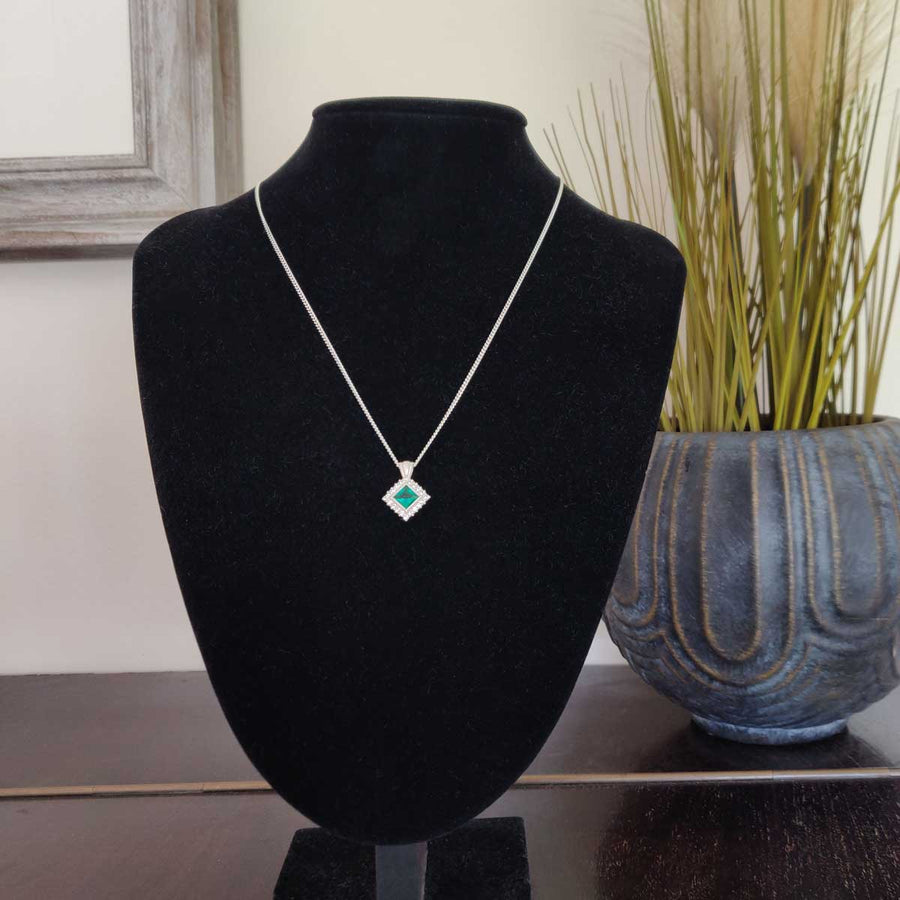 Princess cut emerald and white sapphire cluster necklace in argentium silver on black bust