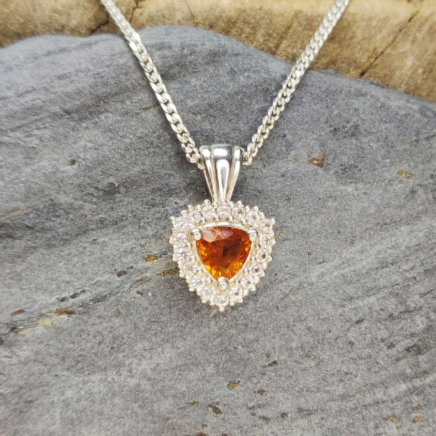 Trillion cut citrine with white sapphire cluster necklace on slate background