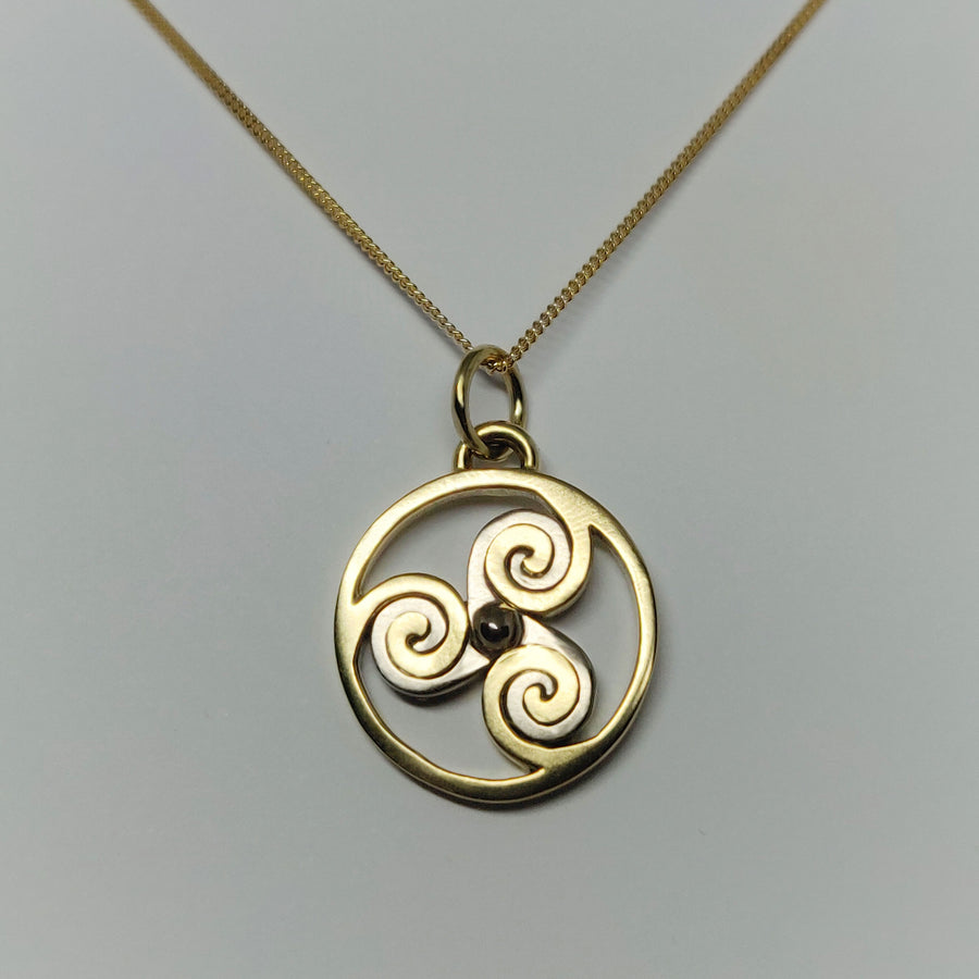 18K White and Yellow Gold Triskellion Pendant and Necklace on a white background