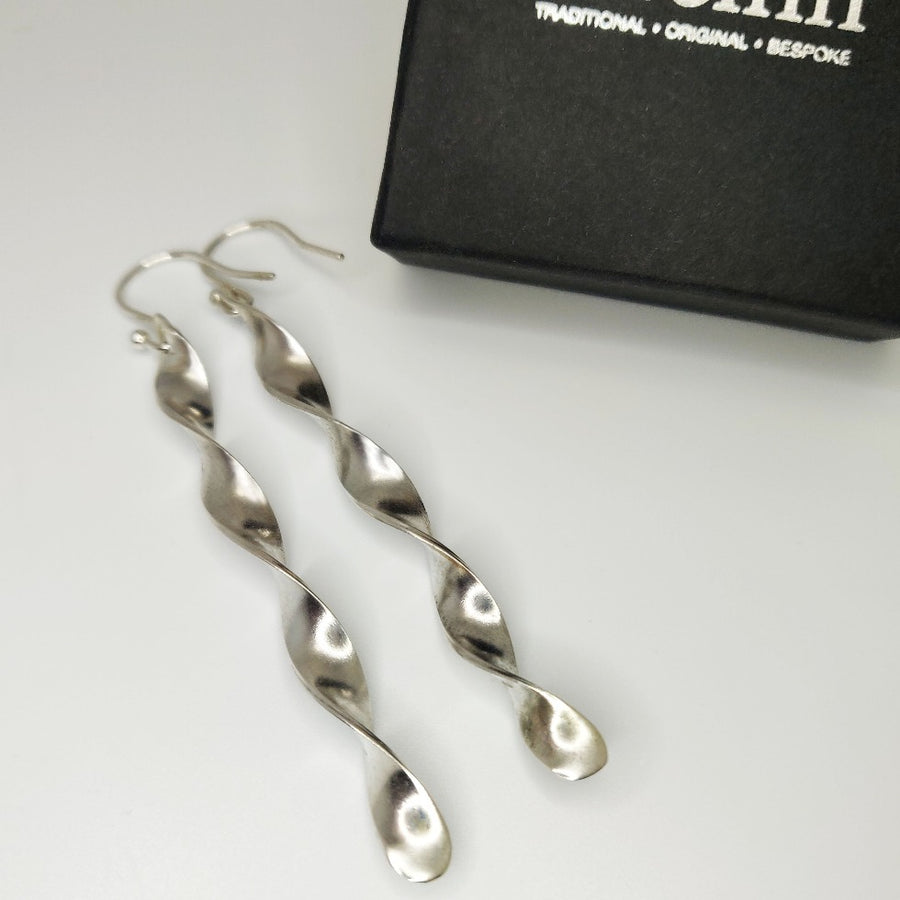 Argentium Silver Twist earrings on a white background with a branded box.