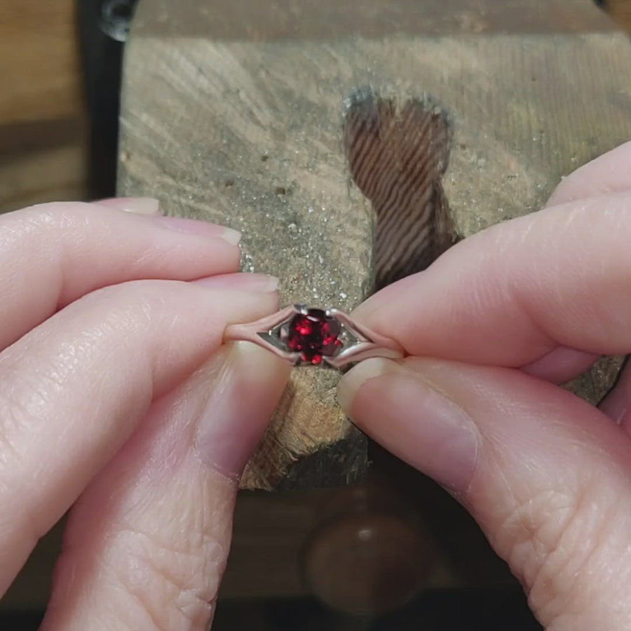 Video of a garnet claw ring on a workbench