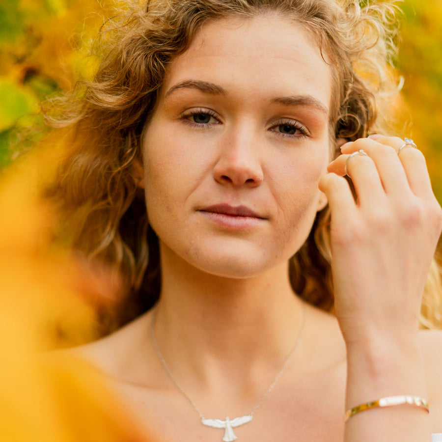 Face on image of girl wearing gold cuff bracelet