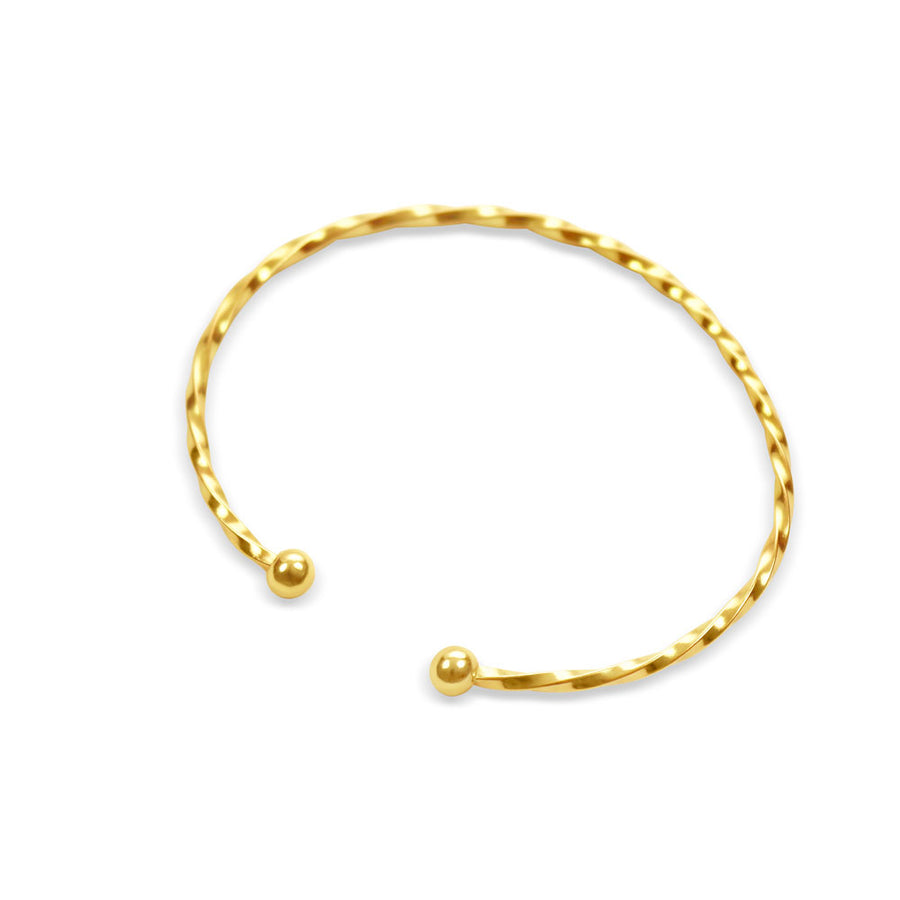 Gold twist bracelet torc on white background