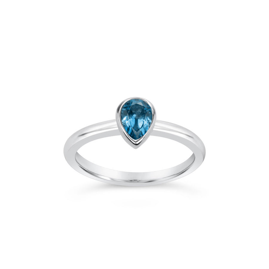 Small pear cut blue topaz argentium silver ring on white background
