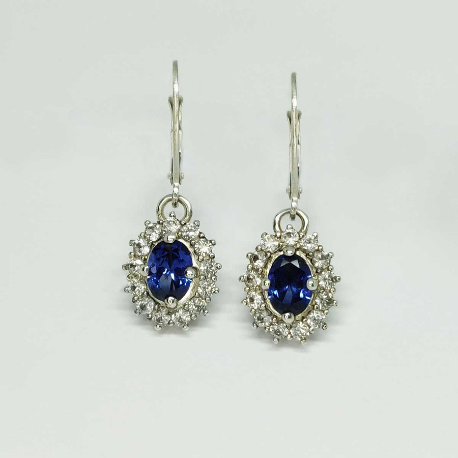 Blue and white sapphire cluster earrings in argentium silver on a white background