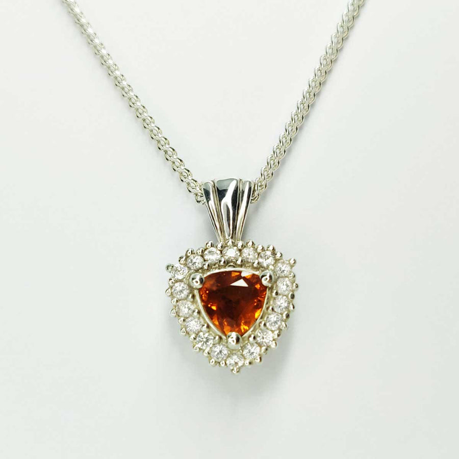 Trillion cut citrine with white sapphire cluster necklace on white background