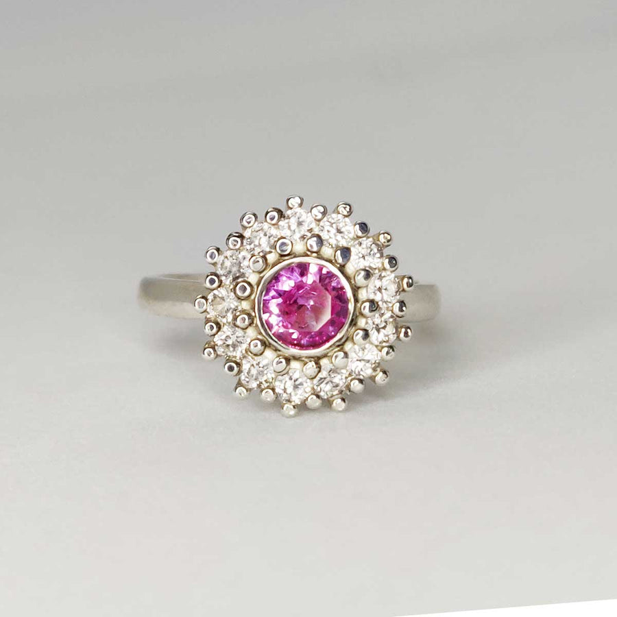 Pink and white sapphire cluster ring in argentium silver on white background